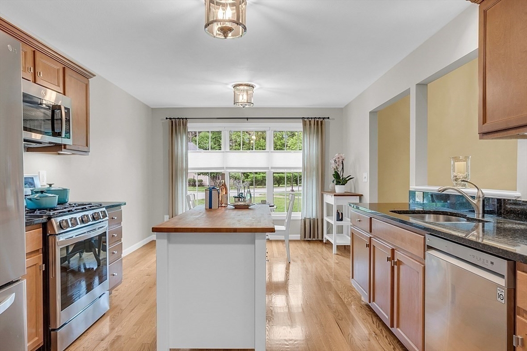 23 Southgate Road, Unit 23 Westford, MA 01886 - Photo 11 of 41 a kitchen with stainless steel appliances a stove a sink and a refrigerator