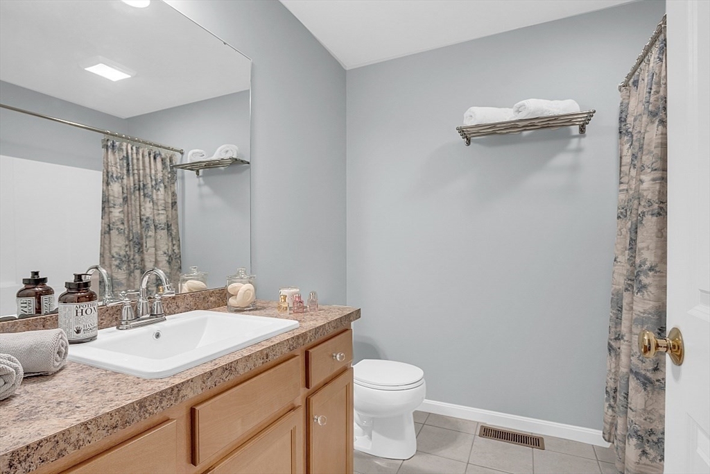 23 Southgate Road, Unit 23 Westford, MA 01886 - Photo 15 of 41 a bathroom with a granite countertop sink toilet and shower