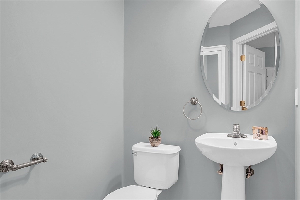23 Southgate Road, Unit 23 Westford, MA 01886 - Photo 18 of 41 a bathroom with a toilet sink and mirror