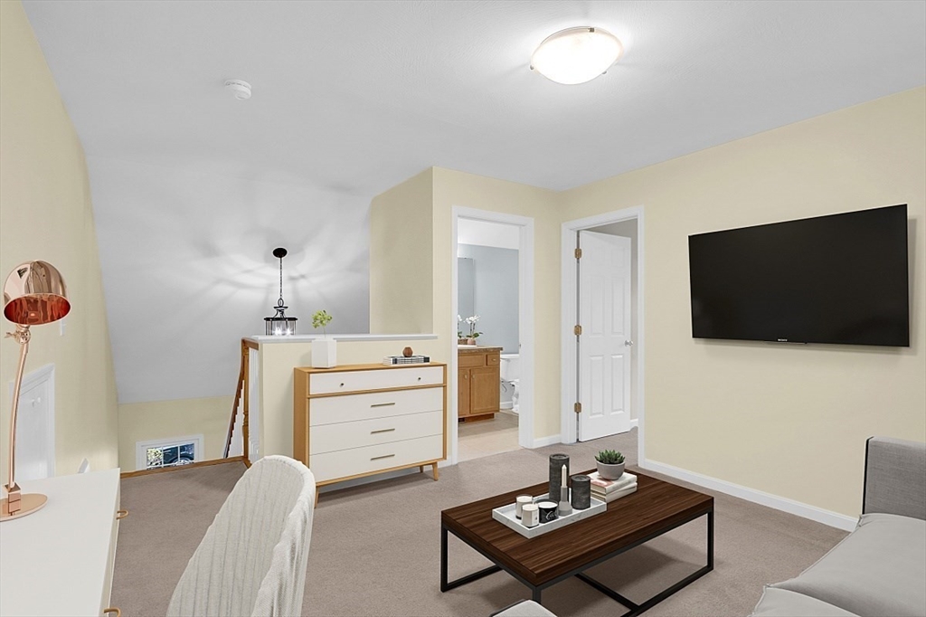 23 Southgate Road, Unit 23 Westford, MA 01886 - Photo 20 of 41 a living room with furniture and a flat screen tv