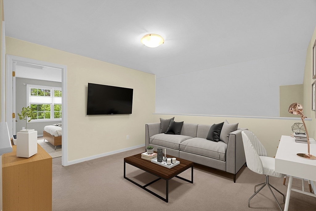 23 Southgate Road, Unit 23 Westford, MA 01886 - Photo 21 of 41 a living room with furniture and a flat screen tv