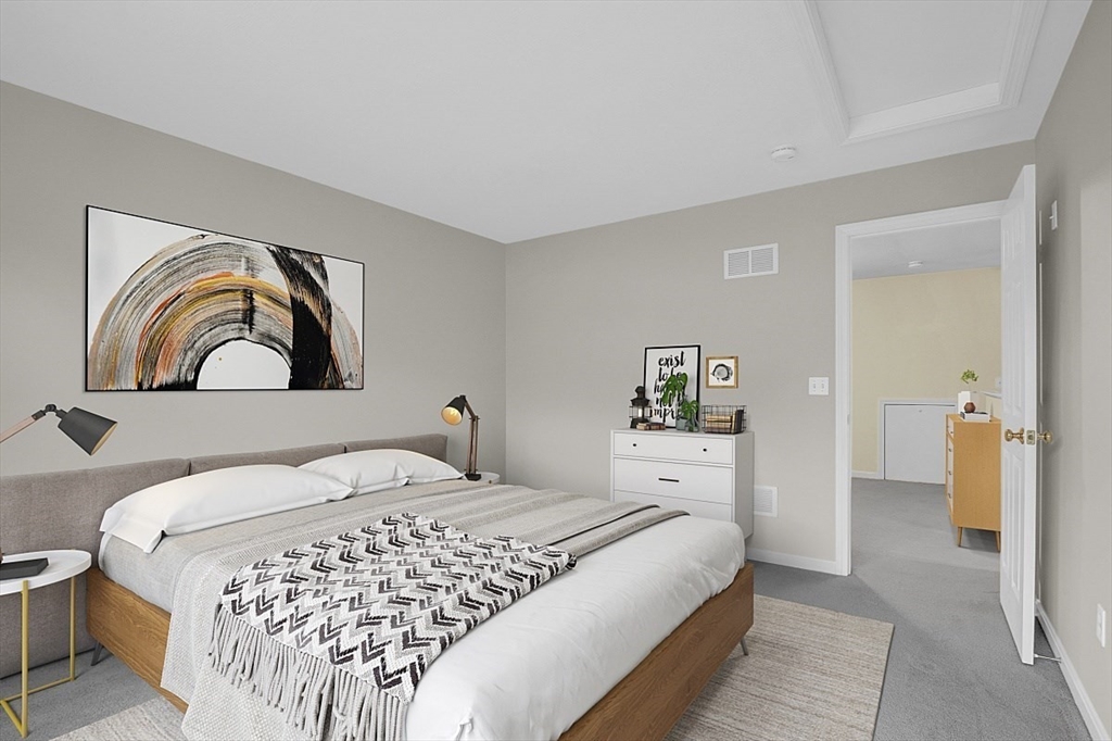 23 Southgate Road, Unit 23 Westford, MA 01886 - Photo 24 of 41 a bedroom with a large bed and a couch