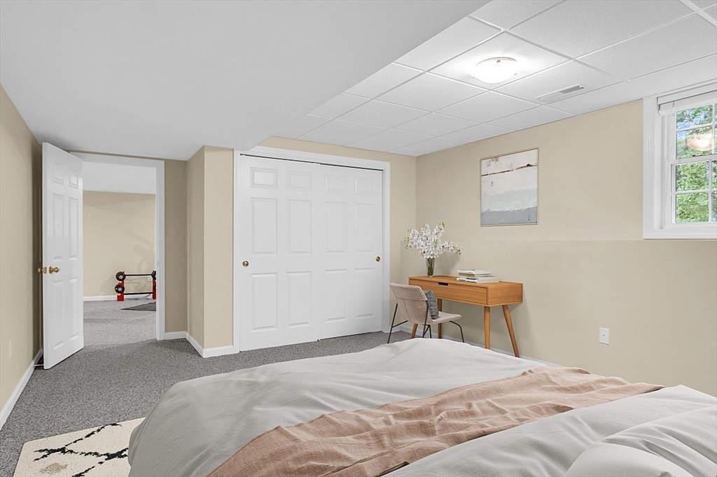 23 Southgate Road, Unit 23 Westford, MA 01886 - Photo 32 of 41 a bedroom with a bed and wooden floor