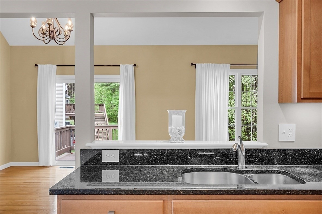 23 Southgate Road, Unit 23 Westford, MA 01886 - Photo 9 of 41 a kitchen with kitchen island granite countertop a sink and a window