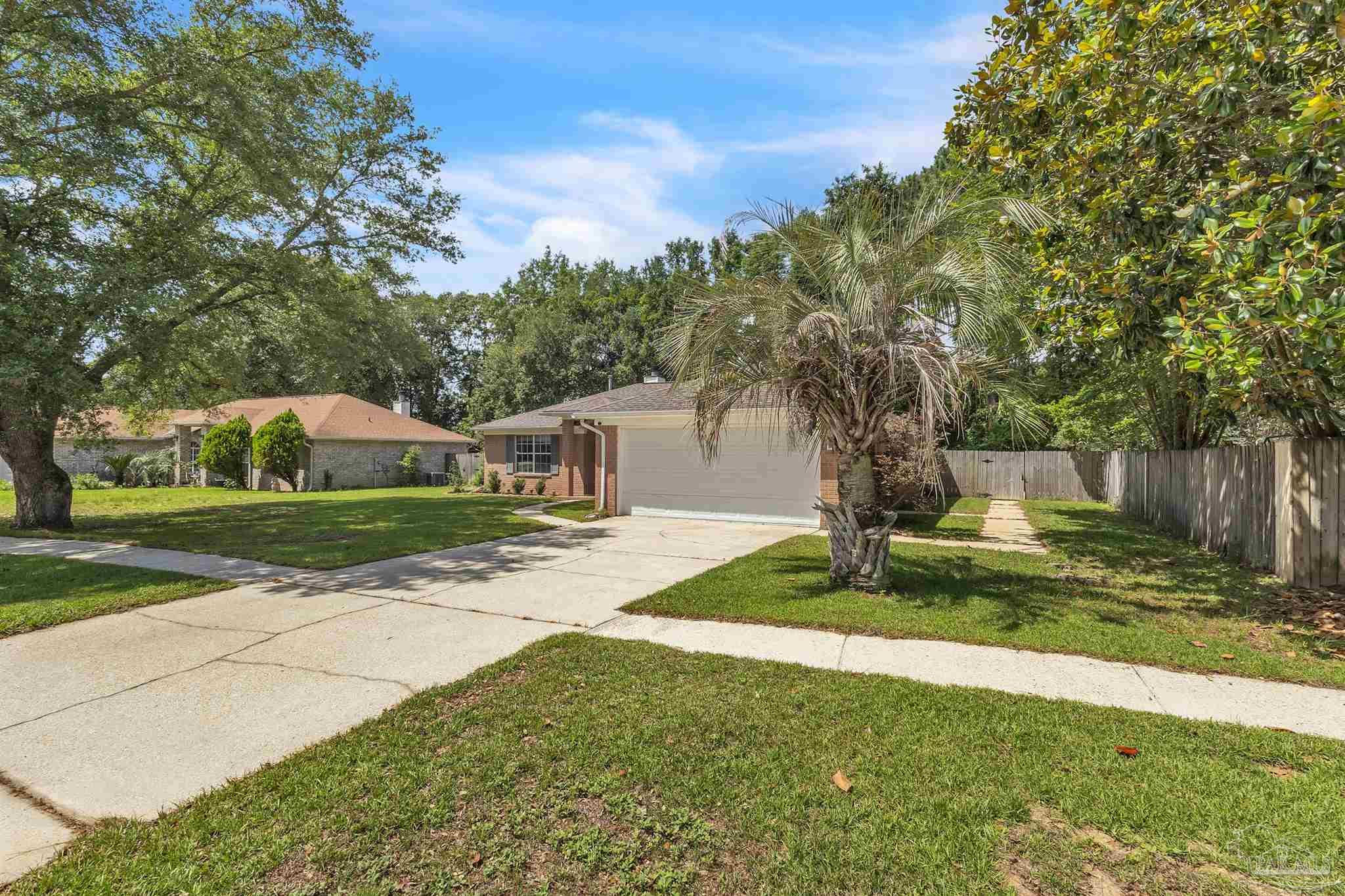 4321 Ridgeland Drive Pace, FL 32571 - Photo 30 of 36 a view of a house with yard and tree s