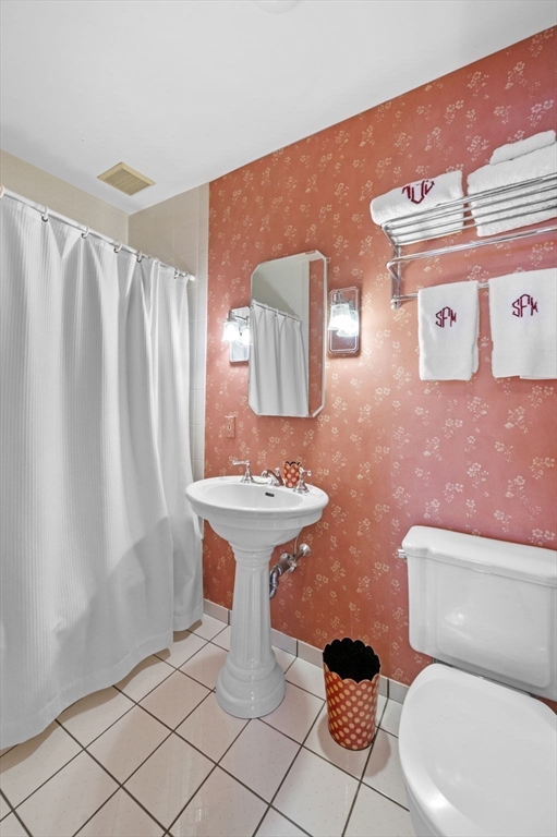 16 Coolidge Road Marblehead, MA 01945 - Photo 19 of 36 a bathroom with a toilet sink and mirror