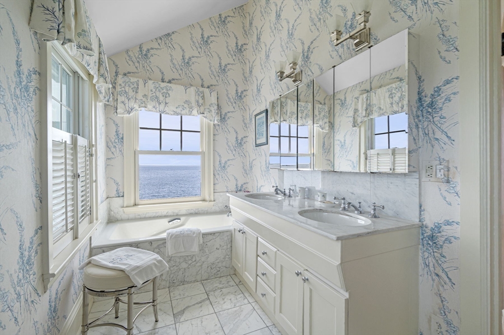 16 Coolidge Road Marblehead, MA 01945 - Photo 23 of 36 a bathroom with a granite countertop sink mirror and a bathtub