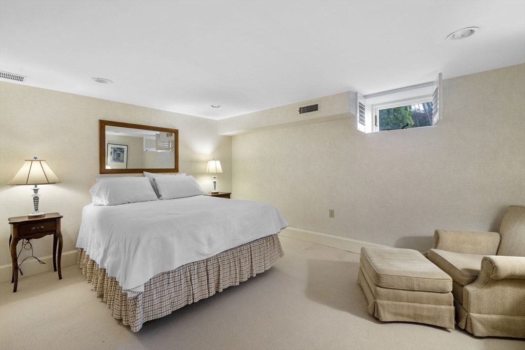 16 Coolidge Road Marblehead, MA 01945 - Photo 26 of 36 a bedroom with a bed couch and a lamp