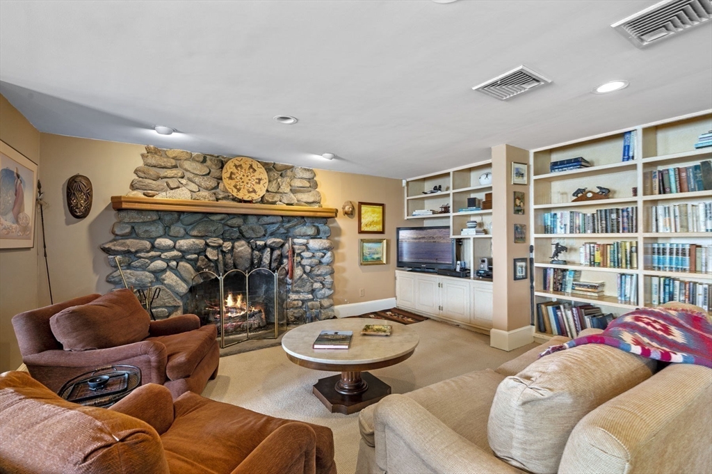 16 Coolidge Road Marblehead, MA 01945 - Photo 27 of 36 a living room with furniture a rug and a bookshelf