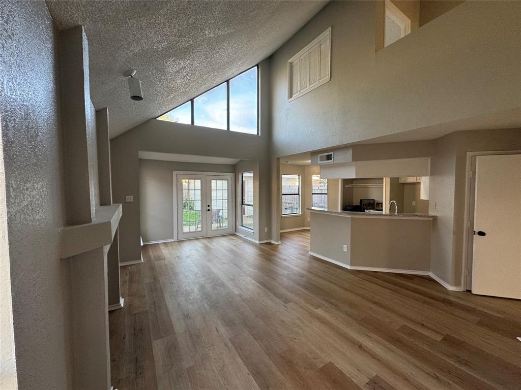 1716 Rancho Drive Mesquite, TX 75149 - Photo 2 of 12 a view of empty room with wooden floor and fan