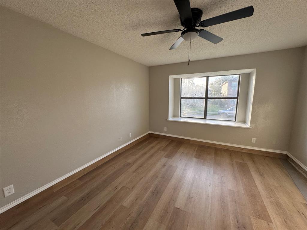 1716 Rancho Drive Mesquite, TX 75149 - Photo 5 of 12 wooden floor in an empty room with a window