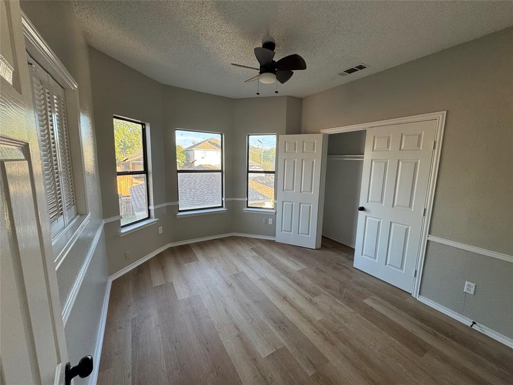 1716 Rancho Drive Mesquite, TX 75149 - Photo 6 of 12 wooden floor in an empty room with a window