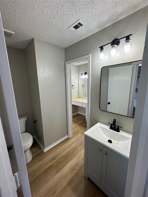 1716 Rancho Drive Mesquite, TX 75149 - Photo 9 of 12 a bathroom with a sink and mirror with toilet
