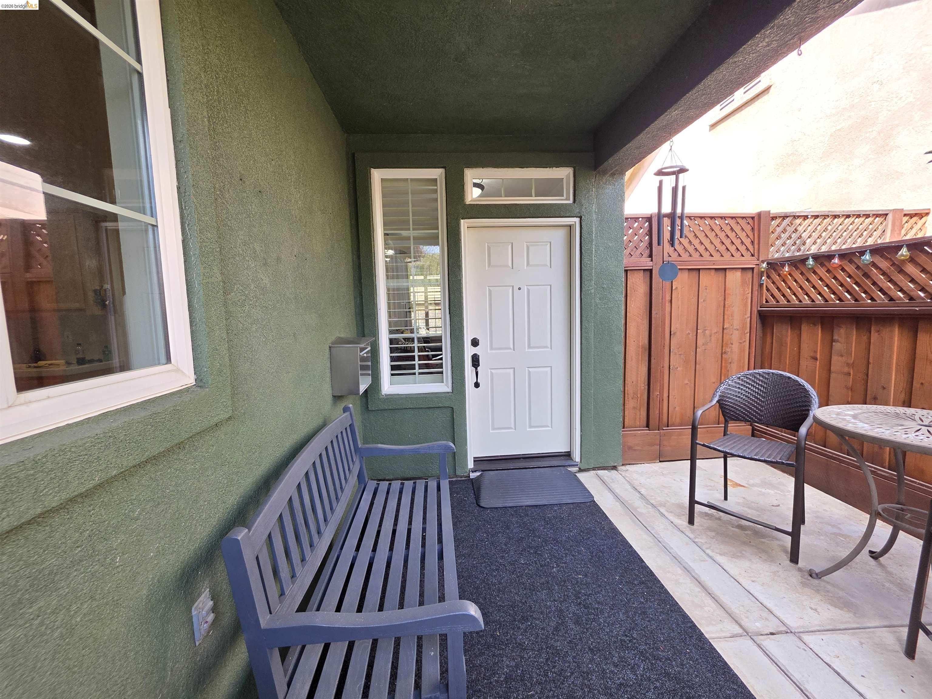 2607 Glow Road Riverbank, CA 95367 - Photo 5 of 42 Covered entryway with a white paneled door, transom window, and adjacent window with plantation shutters