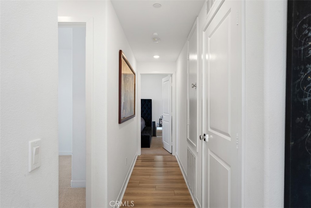 1100 Lasso Way, Unit 204 Rancho Mission Viejo, CA 92694 - Photo 12 of 41 a view of a hallway with wooden shelves