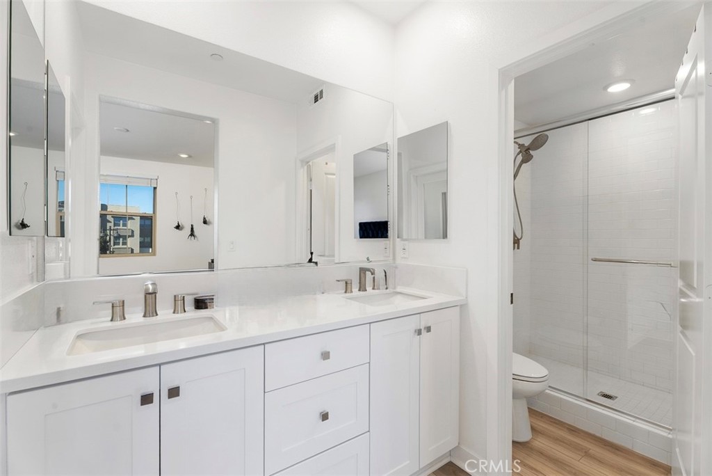 1100 Lasso Way, Unit 204 Rancho Mission Viejo, CA 92694 - Photo 15 of 41 a bathroom with a shower sink vanity mirror and toilet