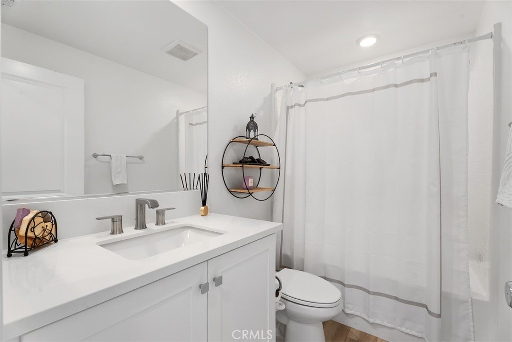 1100 Lasso Way, Unit 204 Rancho Mission Viejo, CA 92694 - Photo 17 of 41 a bathroom with a sink a toilet and a mirror
