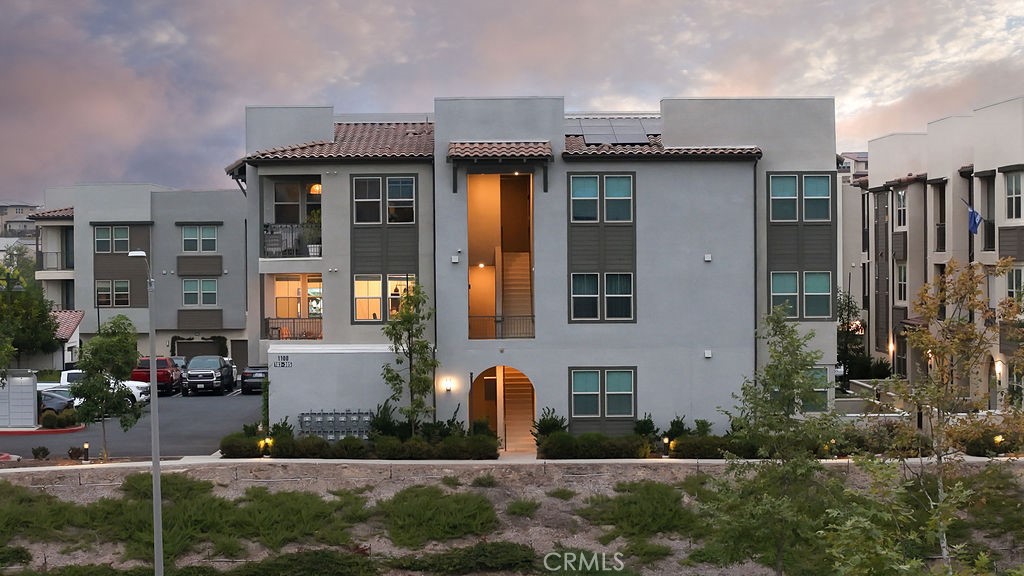 1100 Lasso Way, Unit 204 Rancho Mission Viejo, CA 92694 - Photo 21 of 41 a front view of building with yard