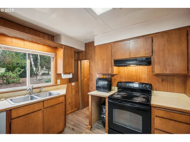 a kitchen with a sink stove and refrigerator