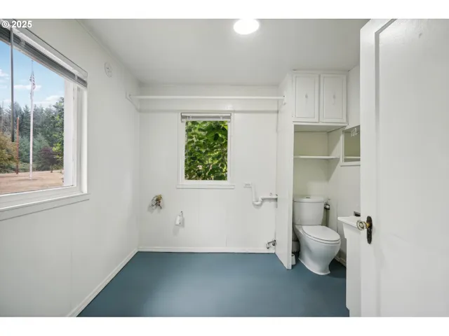 a bathroom with a toilet sink and a window