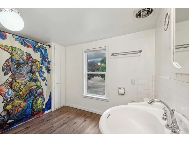 a bathroom with a sink a toilet and a shower curtain