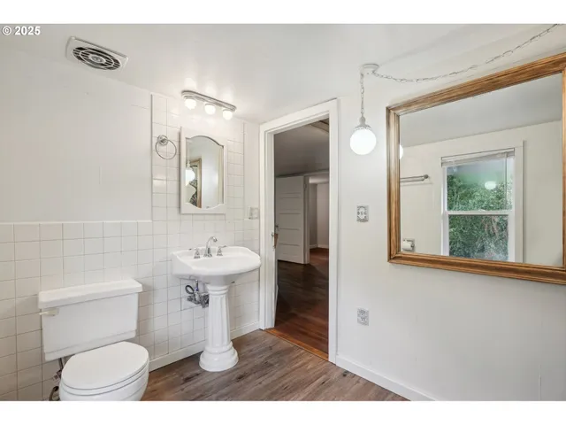 a bathroom with a sink toilet a mirror and shower