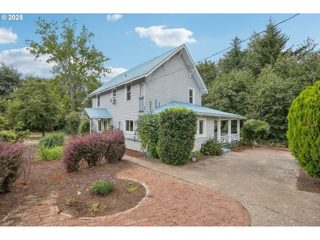 a view of a house with a yard and a garden