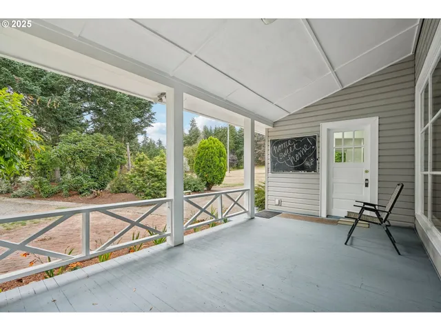 a view of an empty room with wooden floor and windows