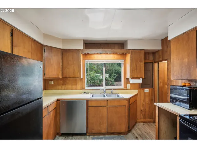 a kitchen with a sink and large window