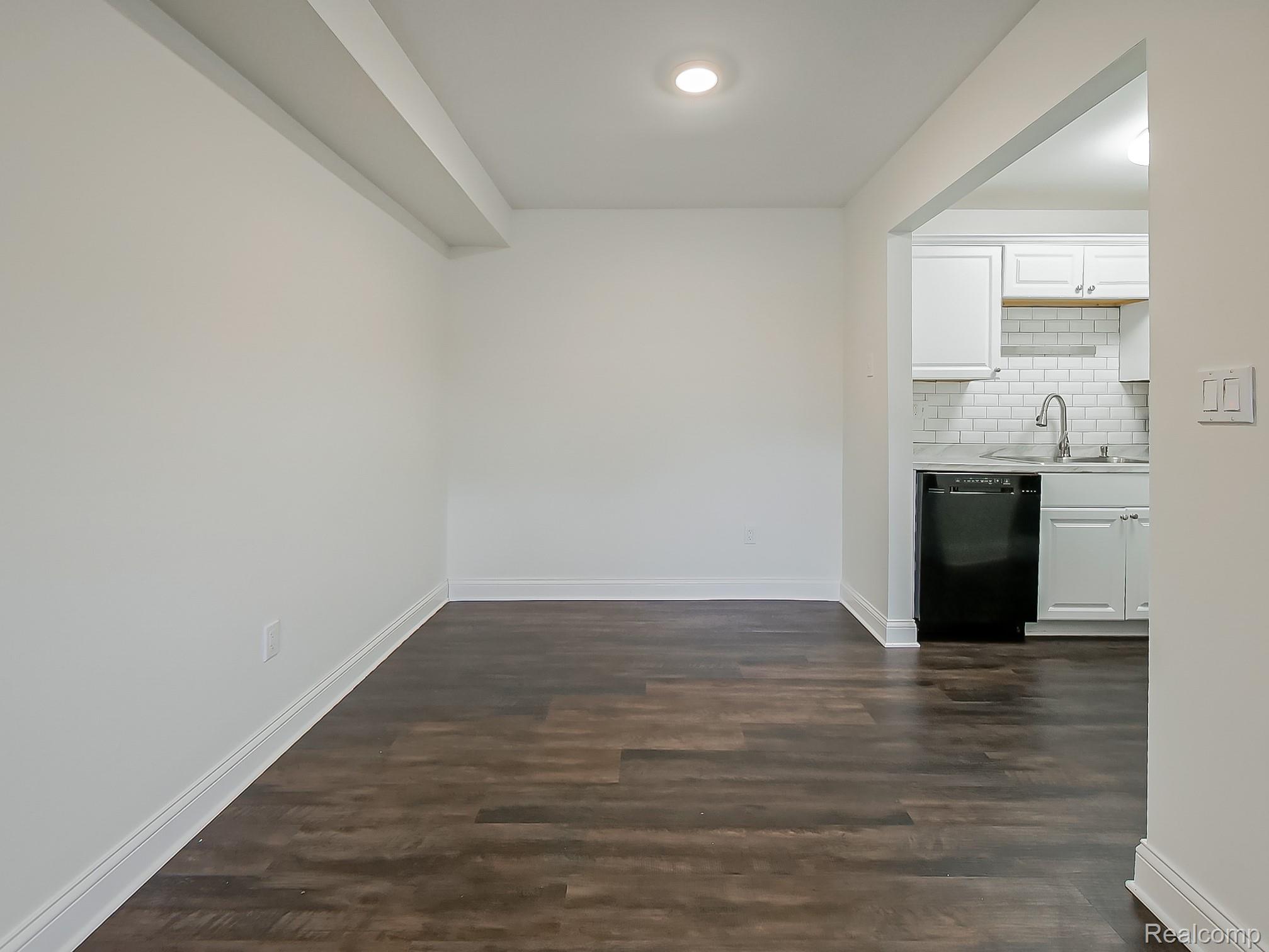 4905 South Crooks Road Royal Oak, MI 48073 - Photo 11 of 28 Unfurnished dining area with baseboards and dark wood-style flooring