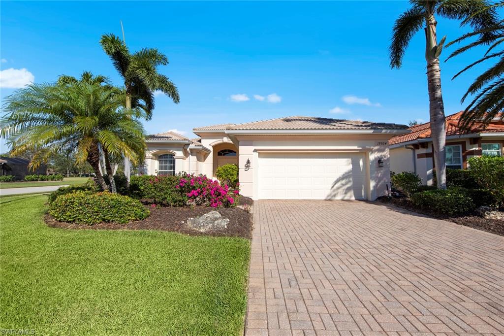 a front view of a house with a yard and a garage