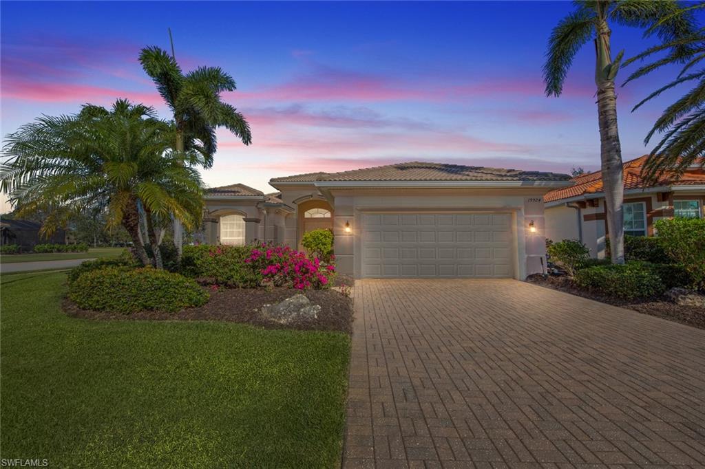 19924 Maddelena Circle Estero, FL 33967 - Photo 2 of 35 a front view of a house with a yard and garage