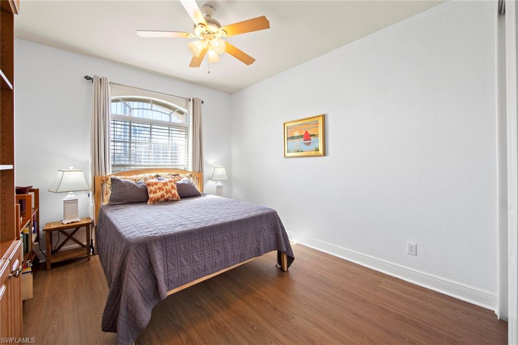 19924 Maddelena Circle Estero, FL 33967 - Photo 23 of 35 a bedroom with a bed and a chandelier