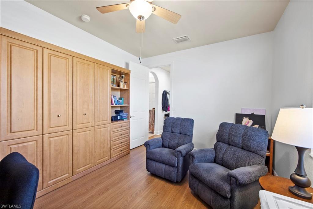19924 Maddelena Circle Estero, FL 33967 - Photo 26 of 35 a living room with furniture and a wooden floor
