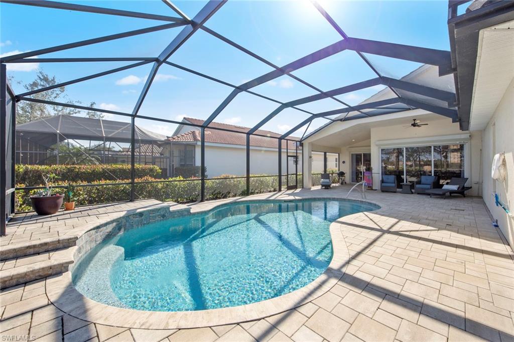19924 Maddelena Circle Estero, FL 33967 - Photo 3 of 35 a view of a swimming pool with a patio