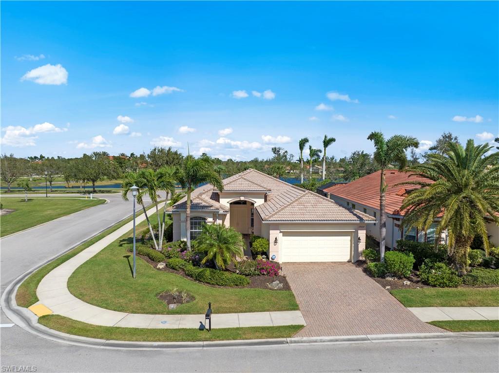 19924 Maddelena Circle Estero, FL 33967 - Photo 4 of 35 a view of a house with a yard and garage
