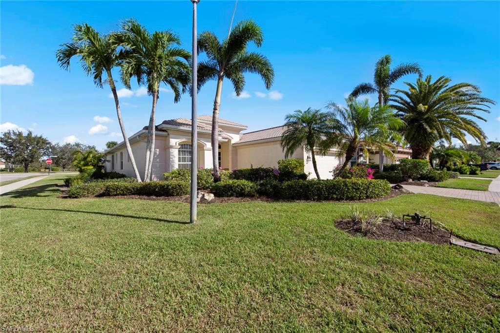 19924 Maddelena Circle Estero, FL 33967 - Photo 5 of 35 a house with palm tree in front of it