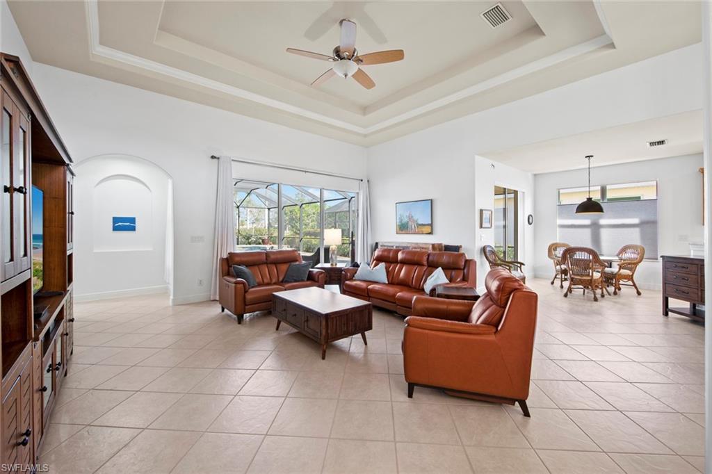 19924 Maddelena Circle Estero, FL 33967 - Photo 8 of 35 a living room with furniture a dining table and a large window