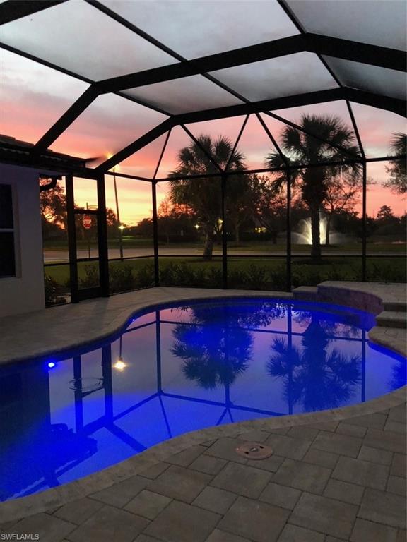19924 Maddelena Circle Estero, FL 33967 - Photo 10 of 35 a view of swimming pool with red chairs in front of building