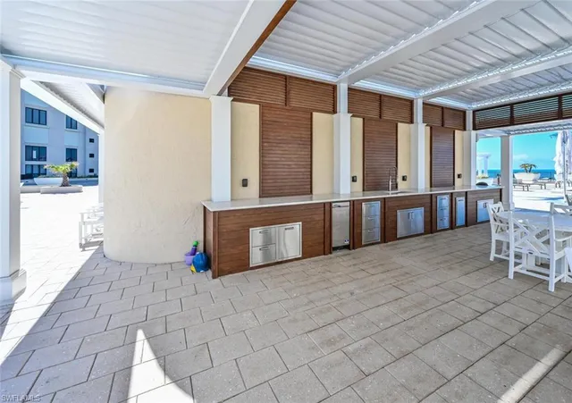a view of a patio with table and chairs and potted plants