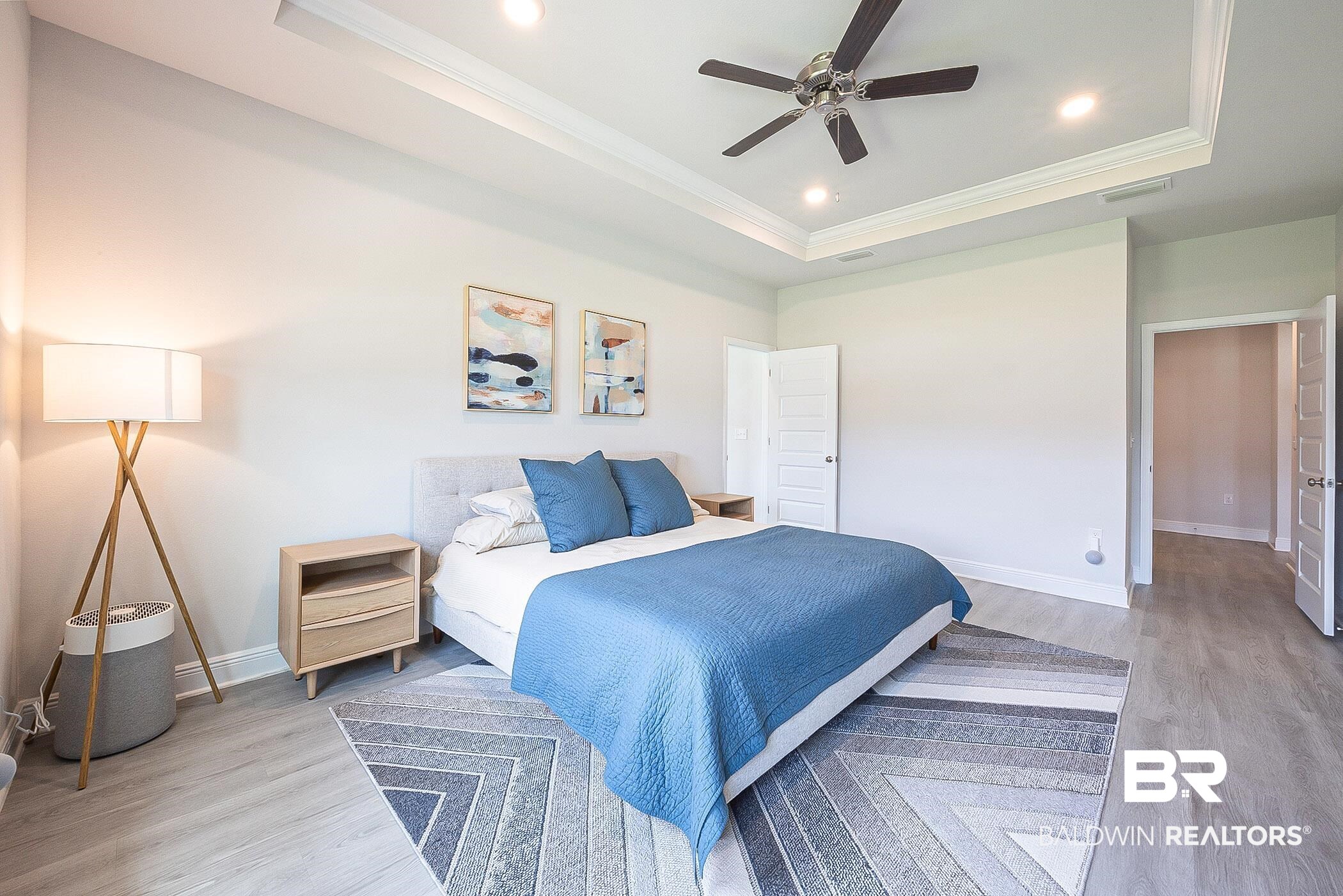 11044 Native Dancer Way Daphne, AL 36526 - Photo 18 of 67 Bedroom featuring crown molding, ceiling fan, a raised ceiling, and light hardwood / wood-style floors