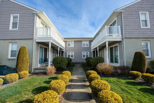 a view of a house with a yard chairs and couches chair