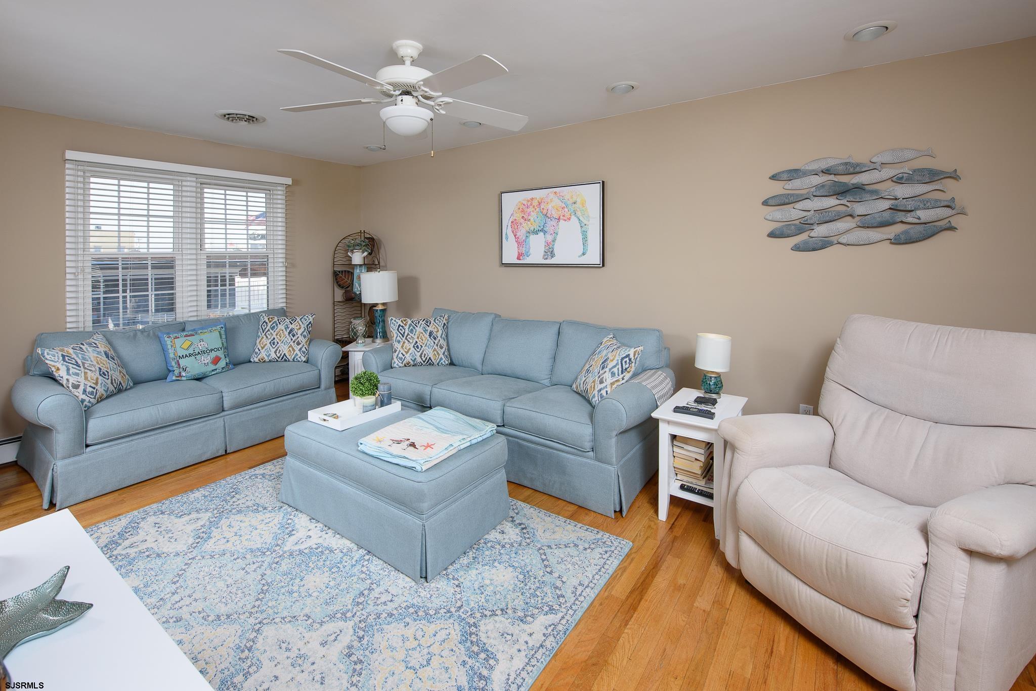 7 South Franklin Avenue, Unit 7 Margate City, NJ 08402 - Photo 2 of 16 a living room with furniture a couch and a window