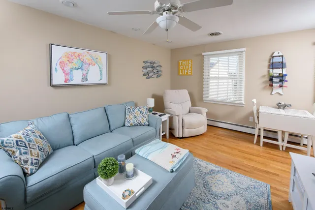 a living room with furniture a rug and a window