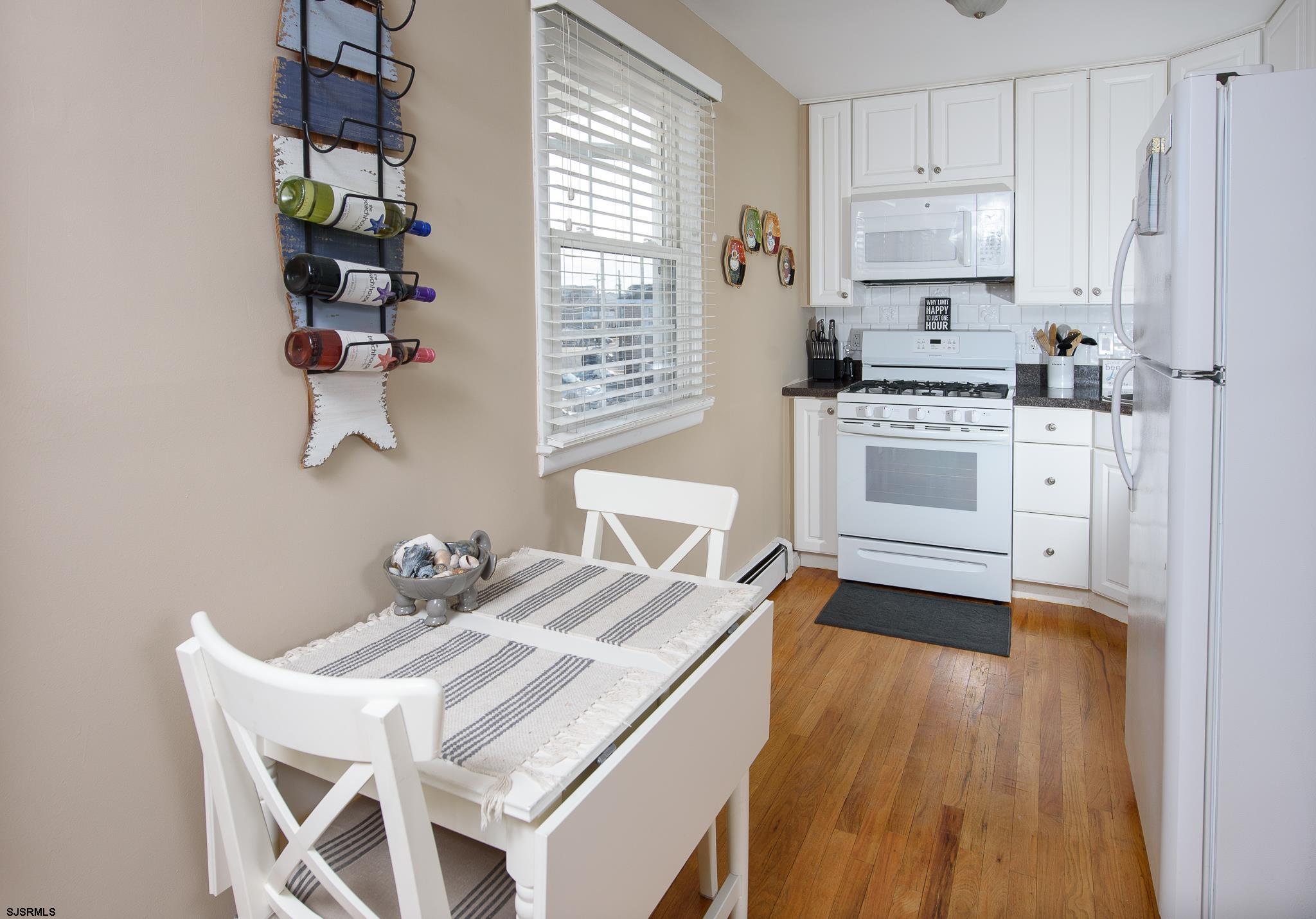 7 South Franklin Avenue, Unit 7 Margate City, NJ 08402 - Photo 4 of 16 a white kitchen with a stove a sink and a refrigerator