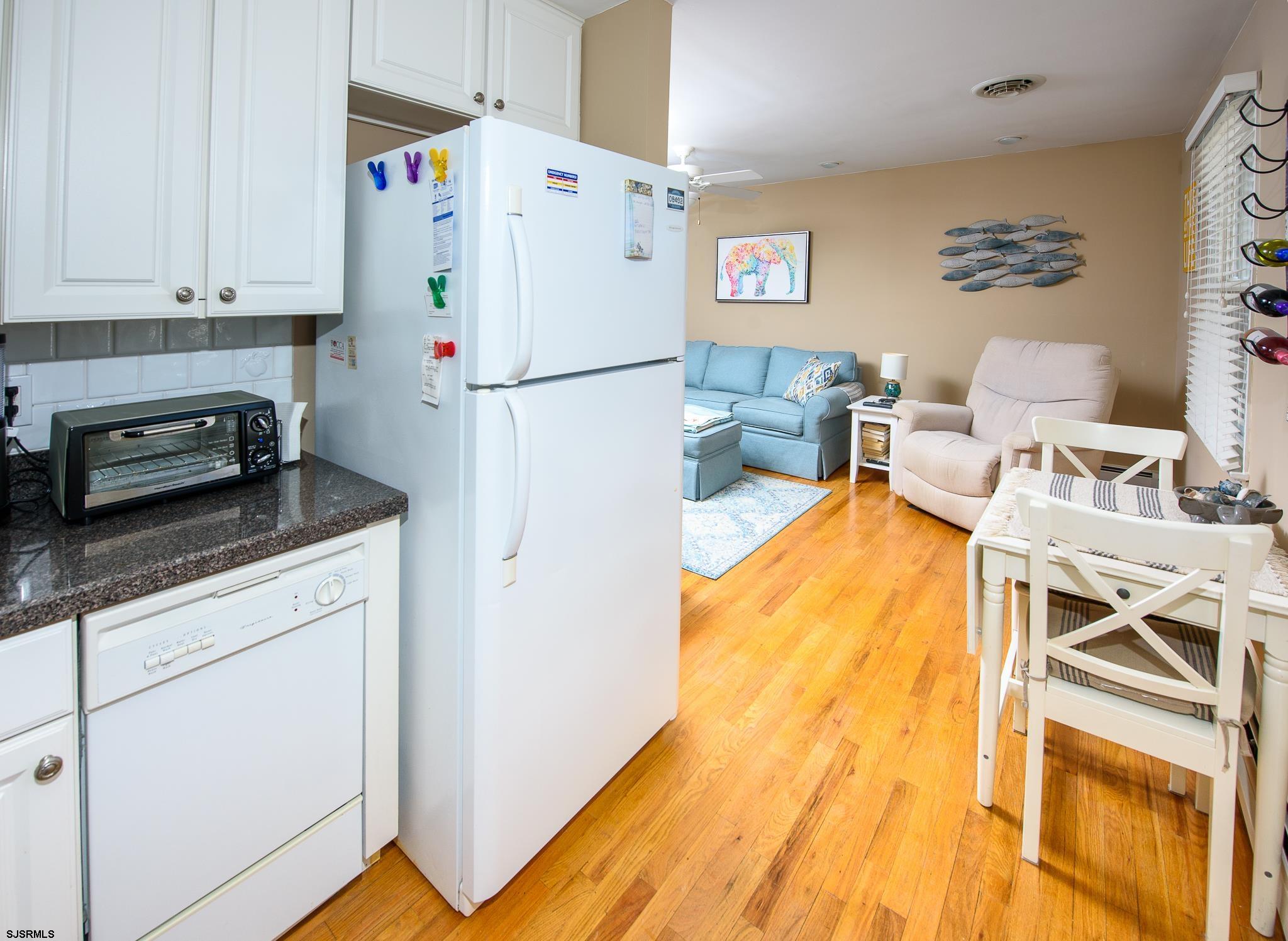 7 South Franklin Avenue, Unit 7 Margate City, NJ 08402 - Photo 7 of 16 a bed room with a bed and a stove