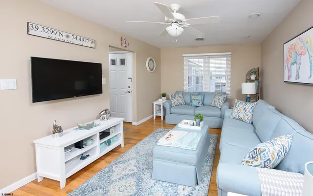 a living room with furniture and a flat screen tv