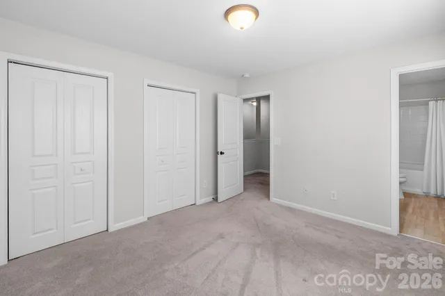 a bedroom with a bed and a painting