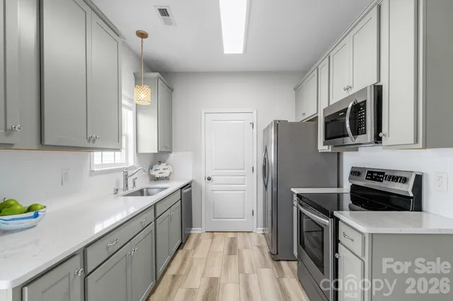 a kitchen with a sink stove and refrigerator