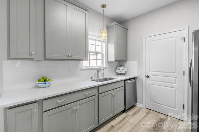 a kitchen with a sink cabinets and window